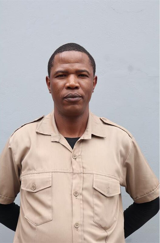 A man wearing a brown guards shirt