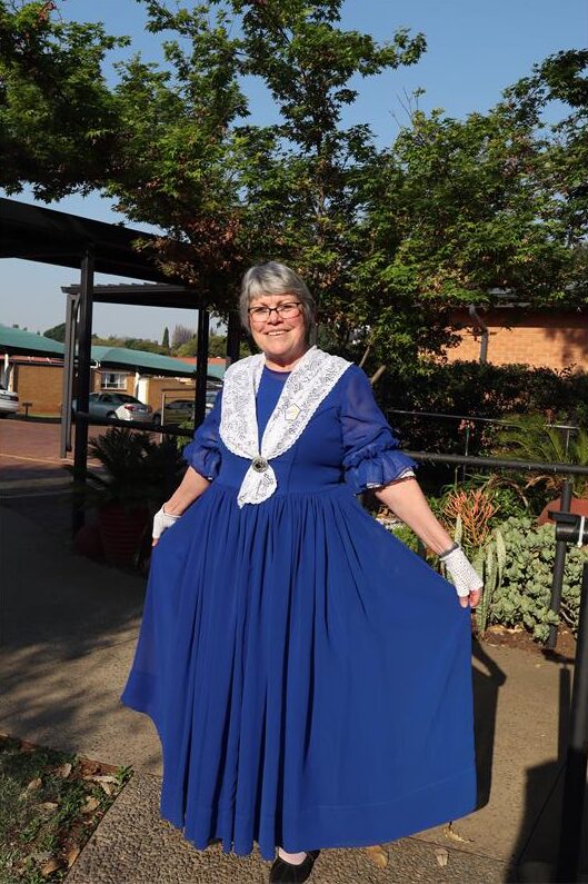 A white lady wearing a blue dress