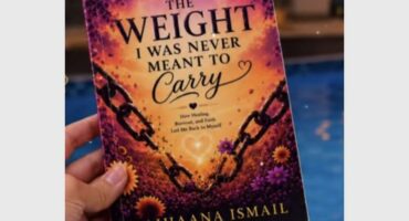 A book cover with the words the weight I was never meant to carry and hand holding the book.