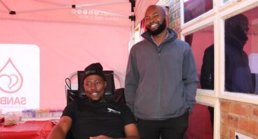 Two black men inside a SANBS gazebo
