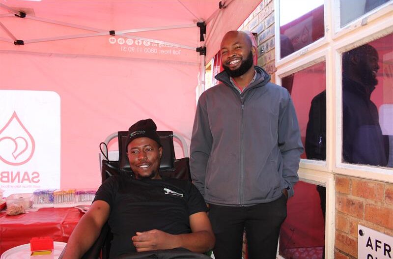 Two black men inside a SANBS gazebo