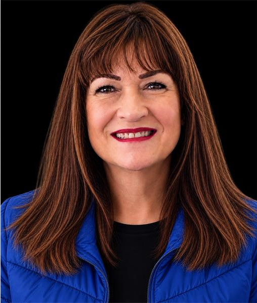 Brown-haired woman wearing a blue jacket