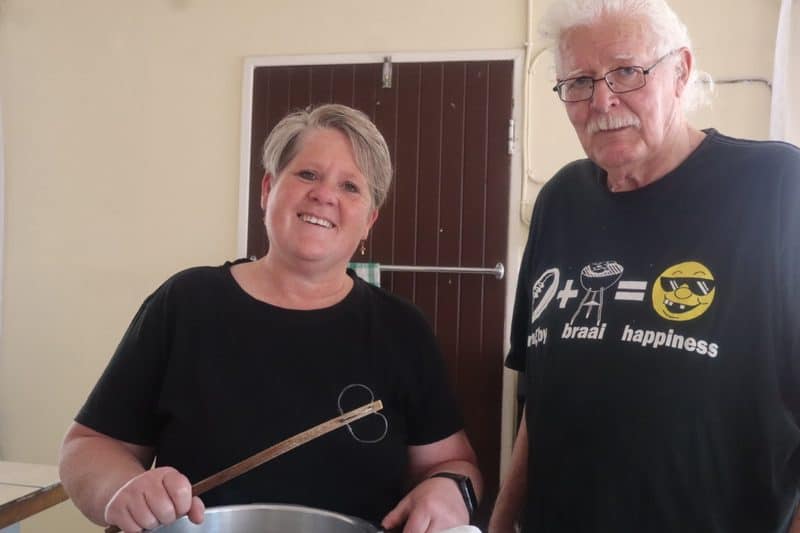 Woman and man standing in a kitchen