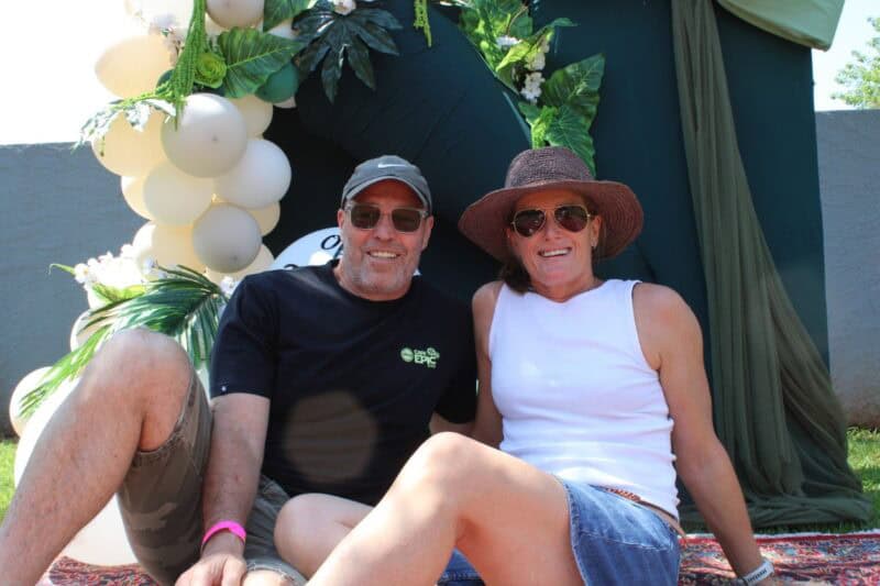 Man and woman sitting in the grass, relaxing