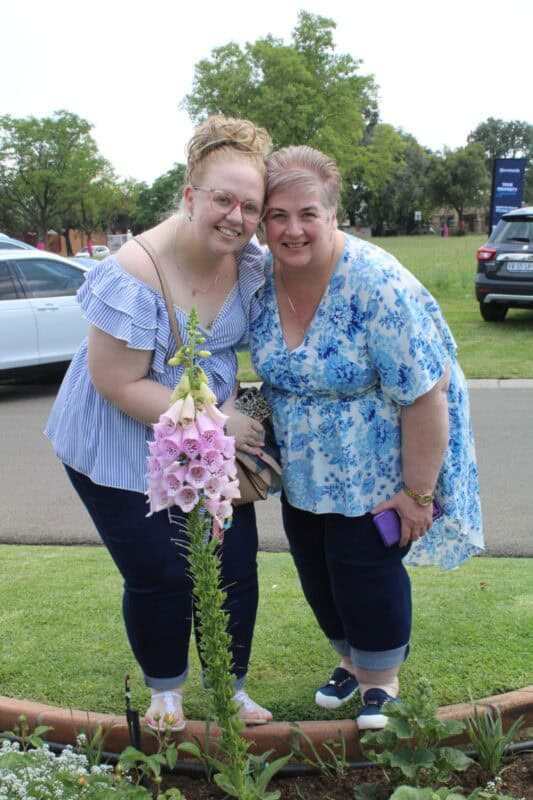 Two women standing in a garden