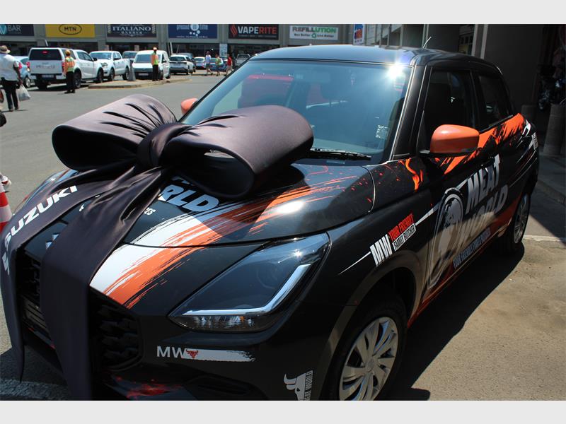 A car branded Meat World with a big black ribbon on the bonnet.