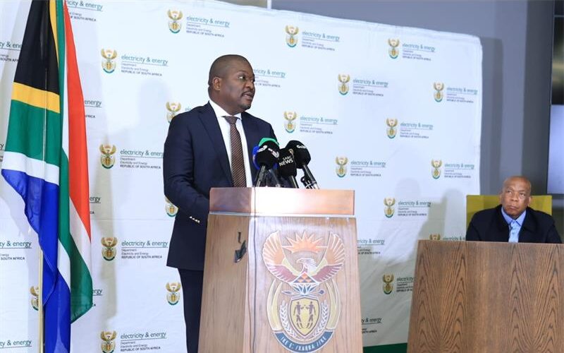 Black man standing at a podium addressing an audience