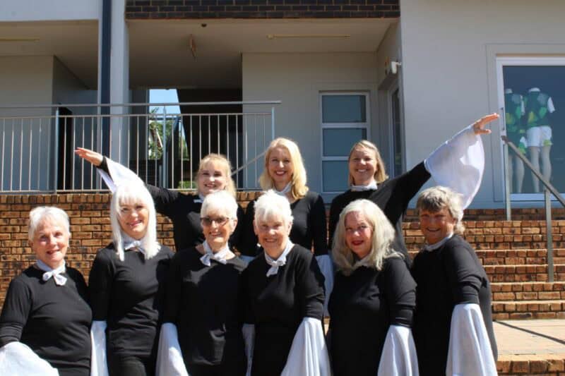 Group of women wearing matching black outfits