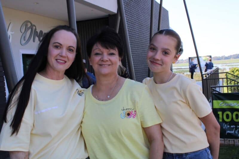 Three women wearing yellow