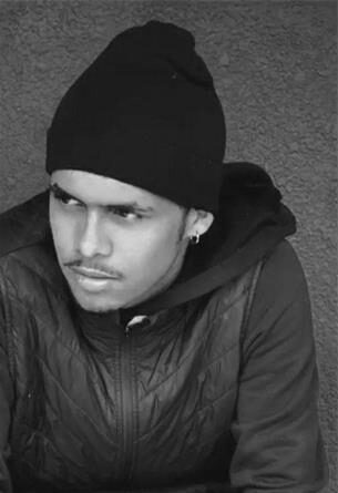 A black and white picture of a boy wearing a jacket and hat