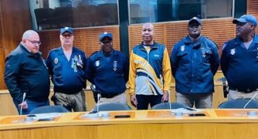 EMPD officers standing behind a table