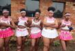 Girls wearing zulu attire in pink and white.
