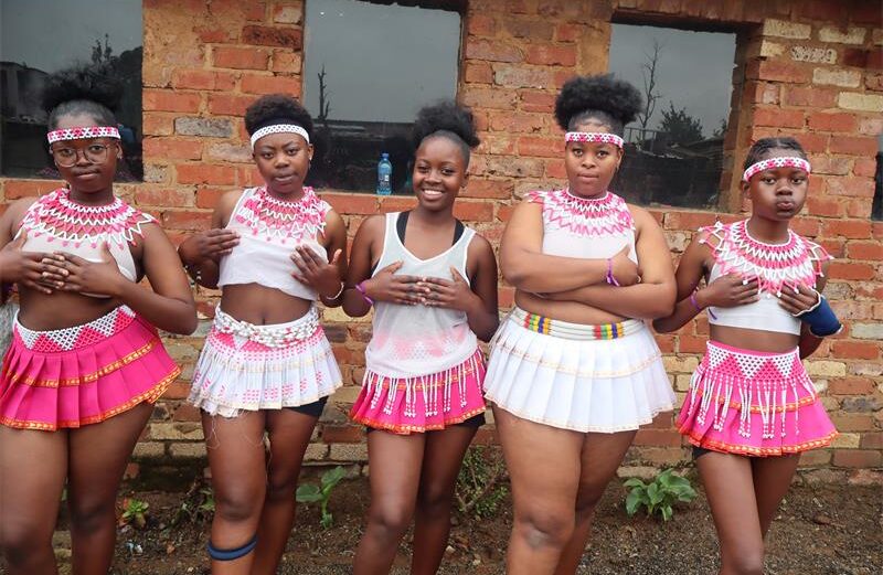 Girls wearing zulu attire in pink and white.