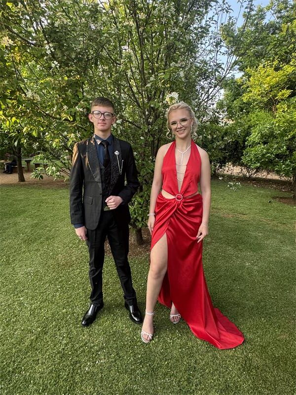 Young man and girl wearing evening wear