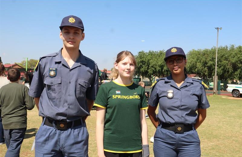 A white girl standing in between two police officers