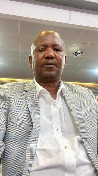 Coloured man wearing a grey suit