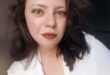 A lady with a red lipstick and a white shirt