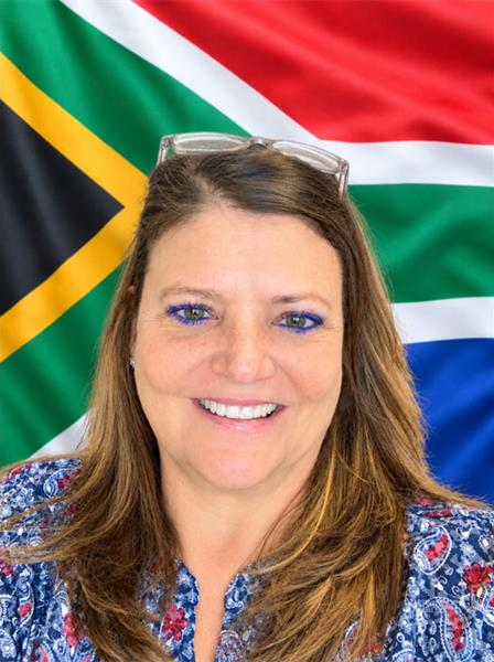 White woman with the South African flag in the back ground
