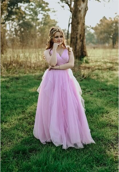 Girl in evening wear standing in a natural setting