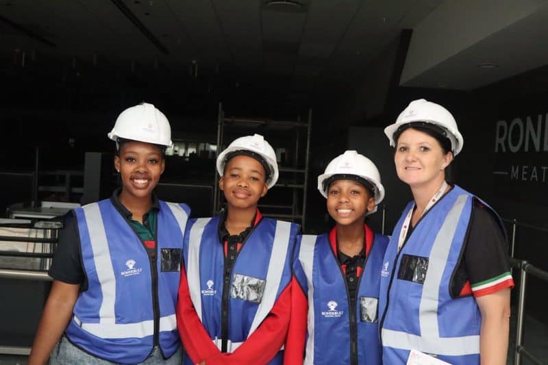 Group of adults and kids wearing hard hats