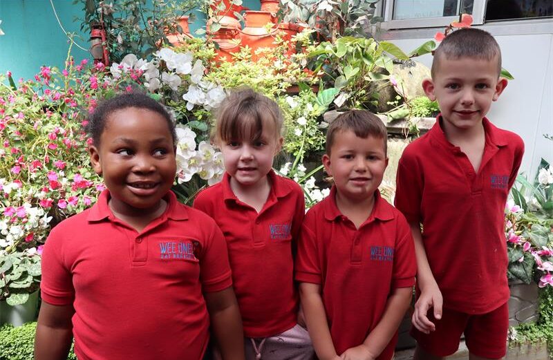 Four children in red school tops