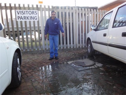 Production manager of the company, Devan Moodley, shows the outlet from which the sewage leak originates.