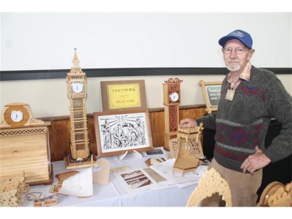 Willie Habig shows his hand-crafted wooden clocks and crafts.