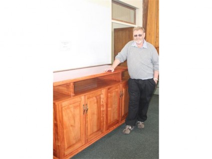 Kevin Keogh with the beautiful entertainment unit he built from rosewood.