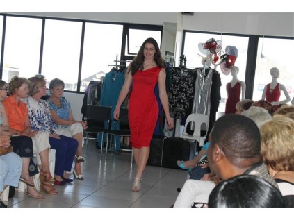 A model struts her stuff in a beautiful red dress.