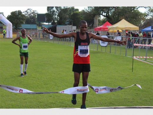 Boxer runner Lucky Mohale crosses the finish line to claim victory in the 21.1km half-marathon at the 2016 Johnson Crane Marathon.