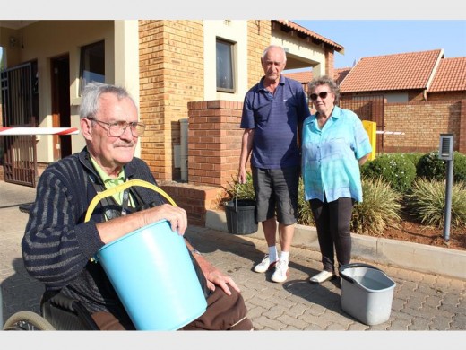 Harry Pohl (left), Roy Hayward and Thelma Dungey collect water at the only tap in Village Walk with flowing water. The tap was fed from nearby water tanks.