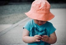 Child wearing an orange hat playing