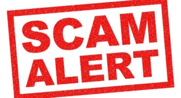 SCAM ALERT red Rubber Stamp over a white background.