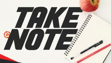 Notepad with two pens and words 'Take Note'