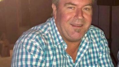 Man wearing a checkered blue and white shirt