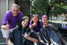 Four people showing a thumbs up