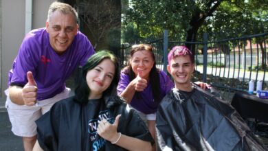 Four people showing a thumbs up