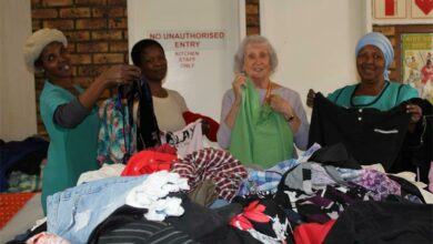 Women standing with clothes