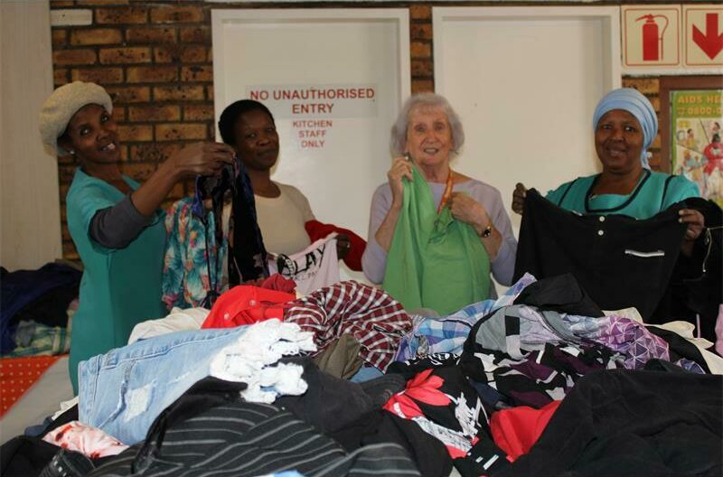 Women standing with clothes