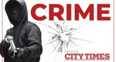 Black and white hooded figure holding a gun with the words crime and benoni city times in red on white background.