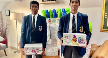 Photo of St Dunstan’s College’s Tanveer and Ranveer Deokali with some of the Santa Shoebox Project boxes that they have pledged for 2025.