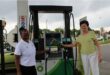 A black woman and a white woman standing at petrol pump with the BP logo