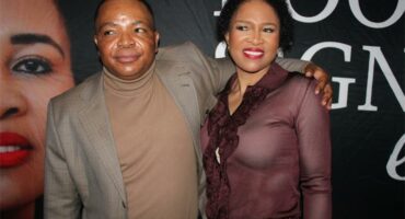 Black man with his arm around a black woman