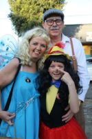 Family of three dressed as the fairy, old man and Pinocchio