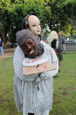 A boy wearing a Halloween costume depicting a head on a plate