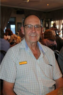 Man wearing glasses and blue shirt.