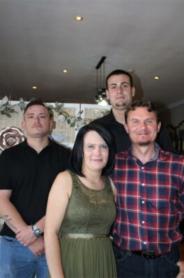 Three men and woman pose for photo