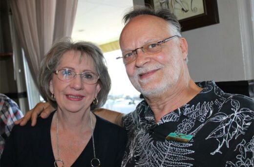Woman and man smiling at the camera