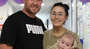 Man and woman holding a baby