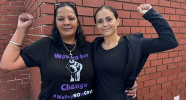 Photo of two women wearing black.